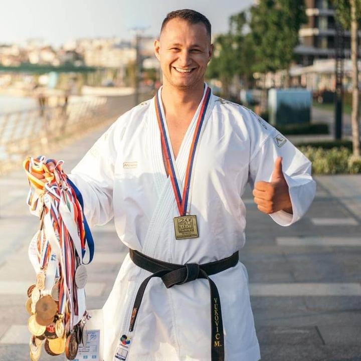 Milos Vukovic, founder of PTD Fitness, with his world championship medals